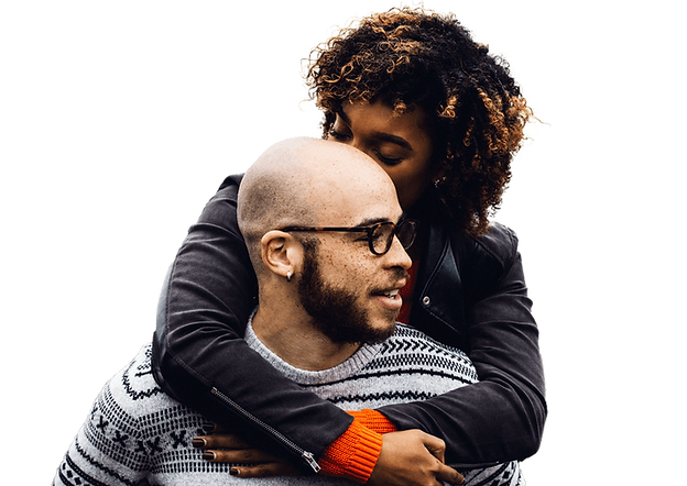 woman hugging a man from behind, wrapping her arms around him, looking in opposite directions